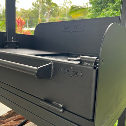 Close-up of a black barbecue grill with 'benot' branding, outdoors.